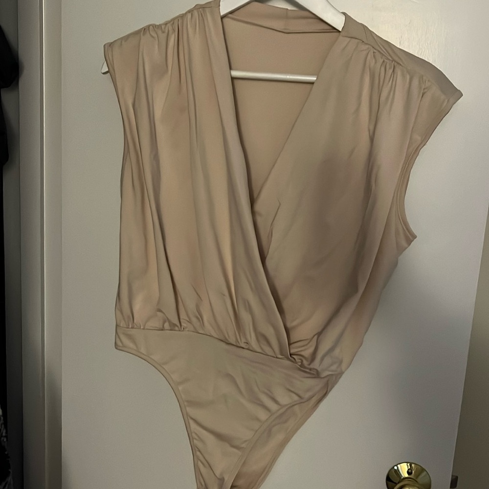 Tan bodysuit with shoulder pads